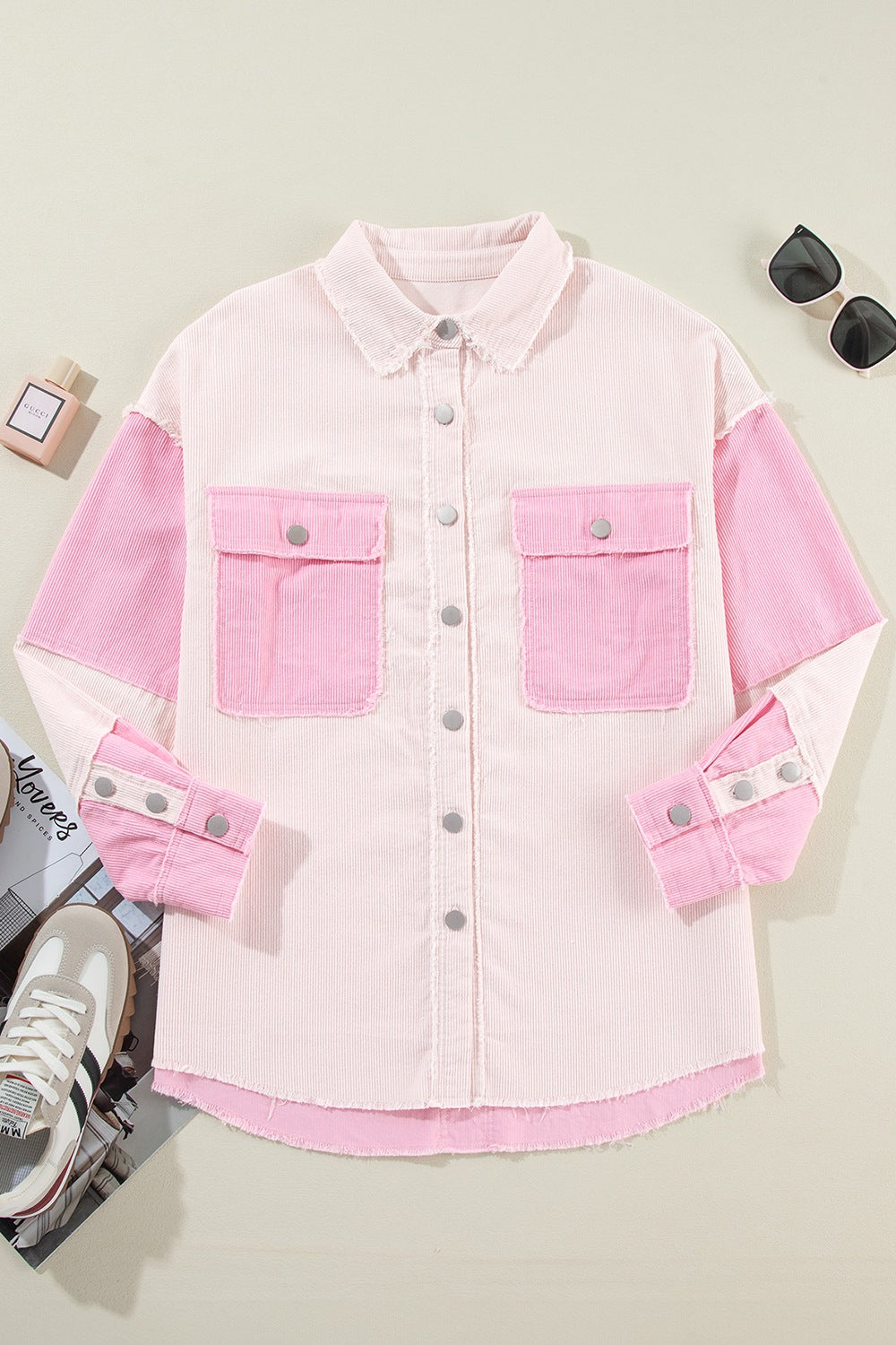 Two-tone exposed seam corduroy shacket with pockets, raw hem, and buttons.