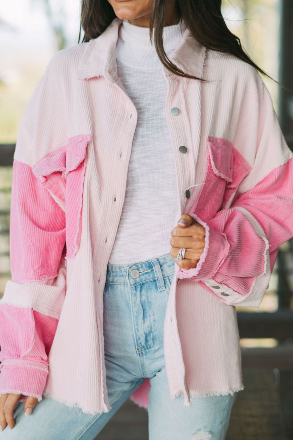 Two-tone exposed seam corduroy shacket with pockets, raw hem, and buttons.