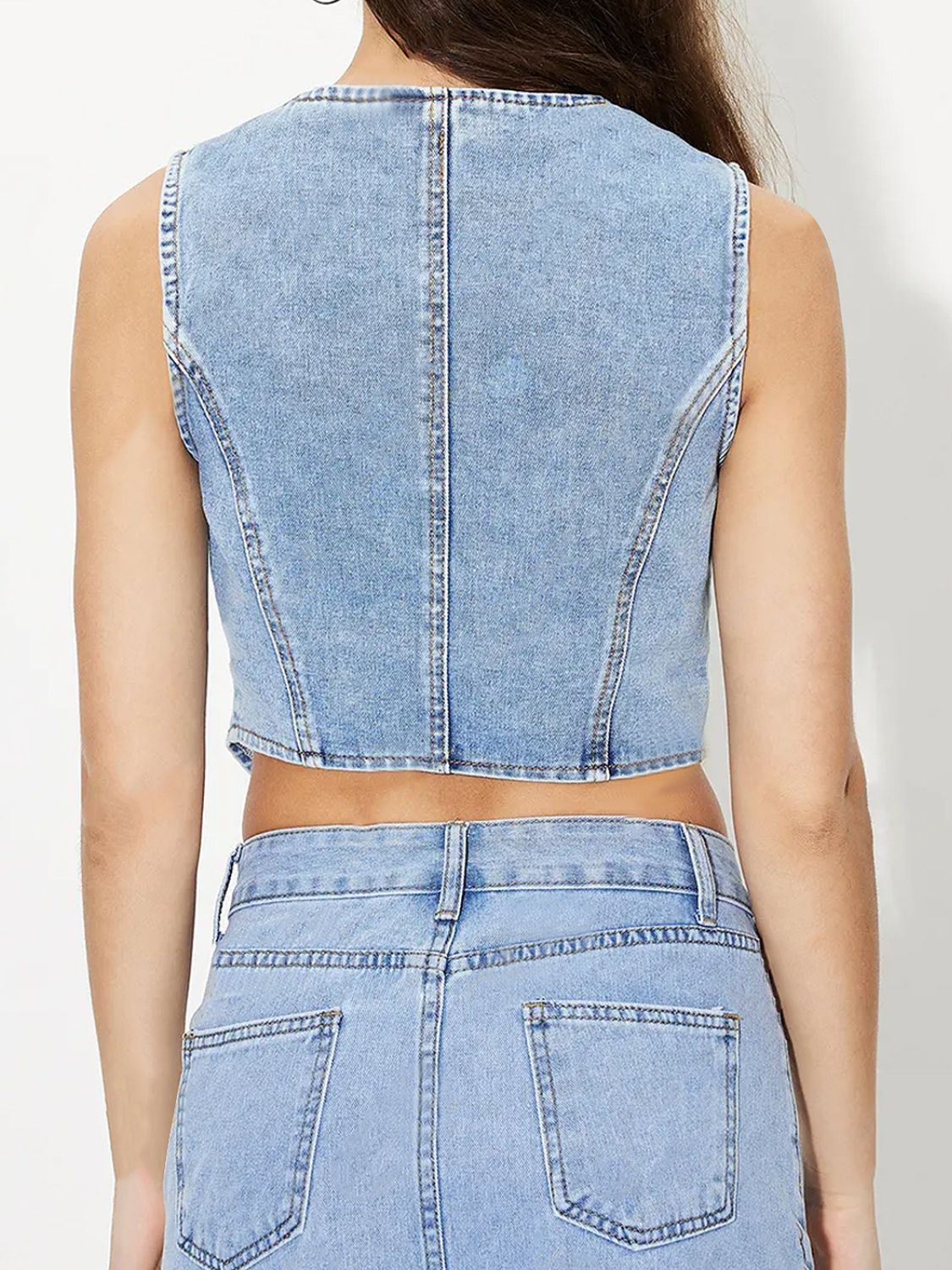 V-neck button up denim vest.