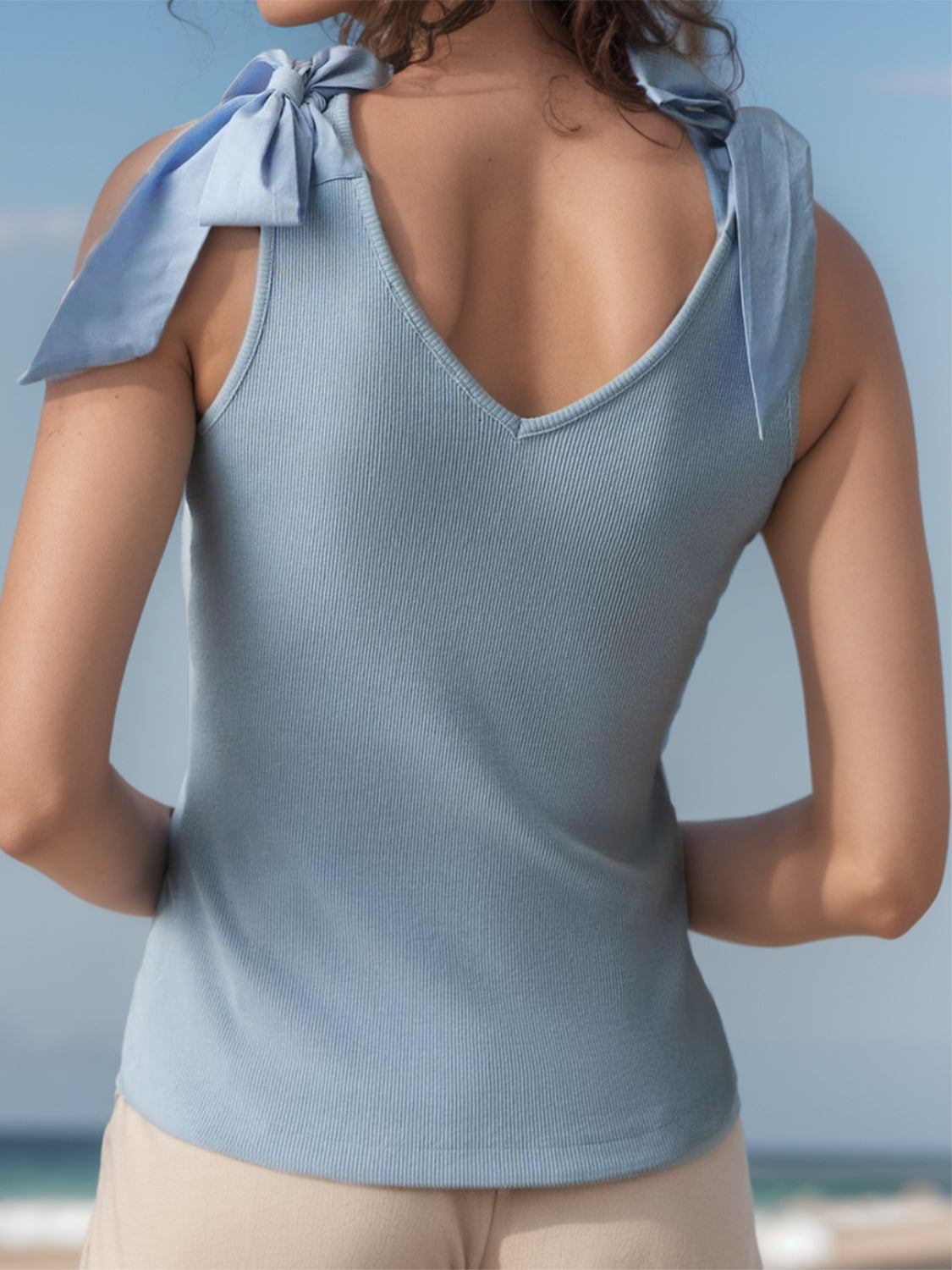 V-neck tie shoulder tank with bow, moderately stretchy.