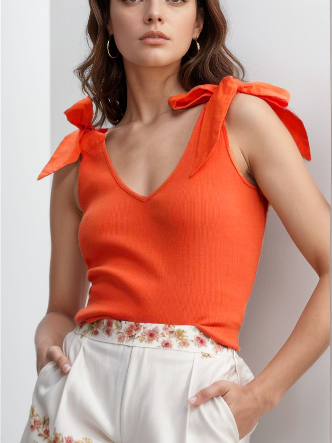 V-neck tie shoulder tank with bow, moderately stretchy.