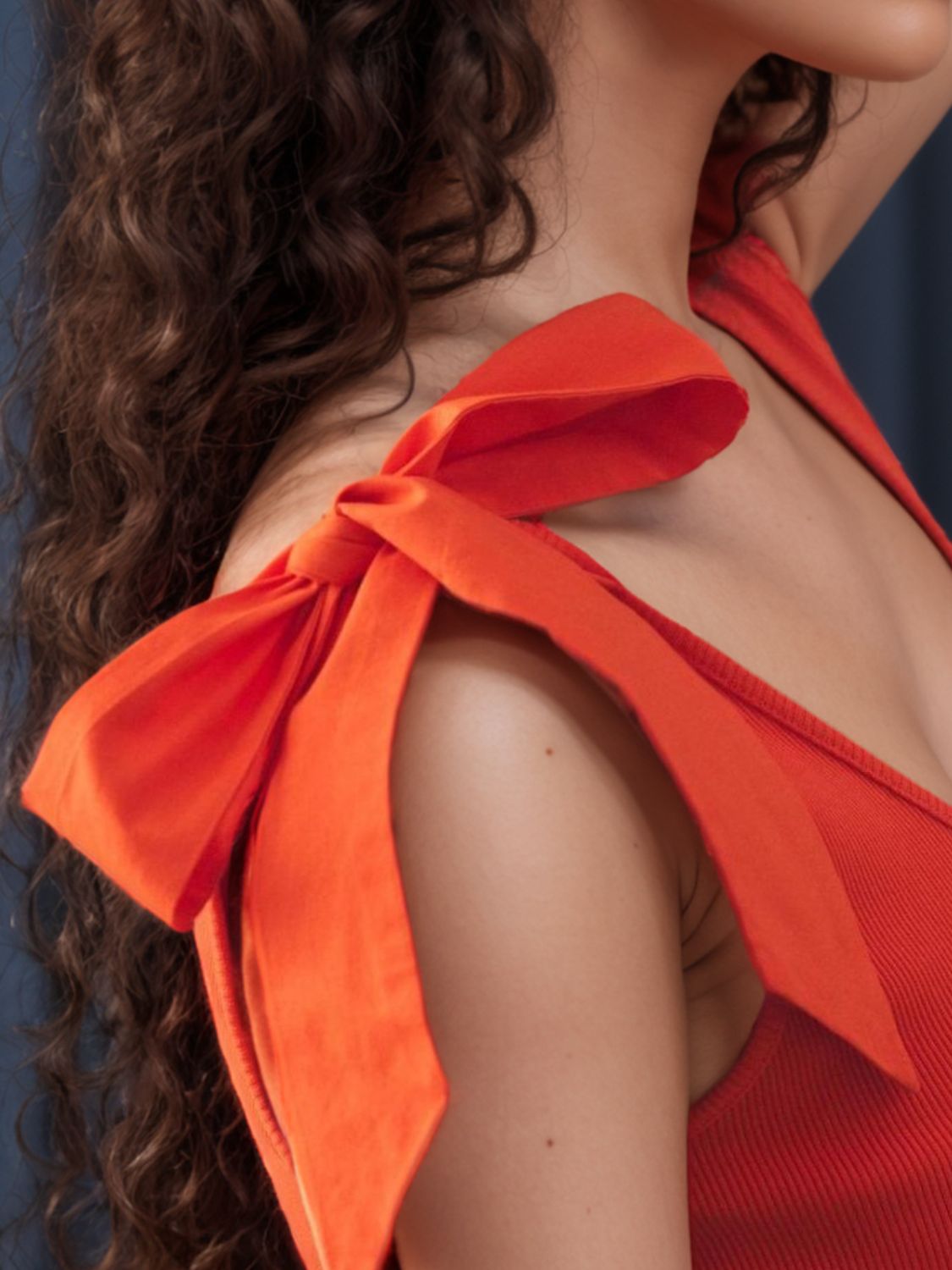 V-neck tie shoulder tank with bow, moderately stretchy.