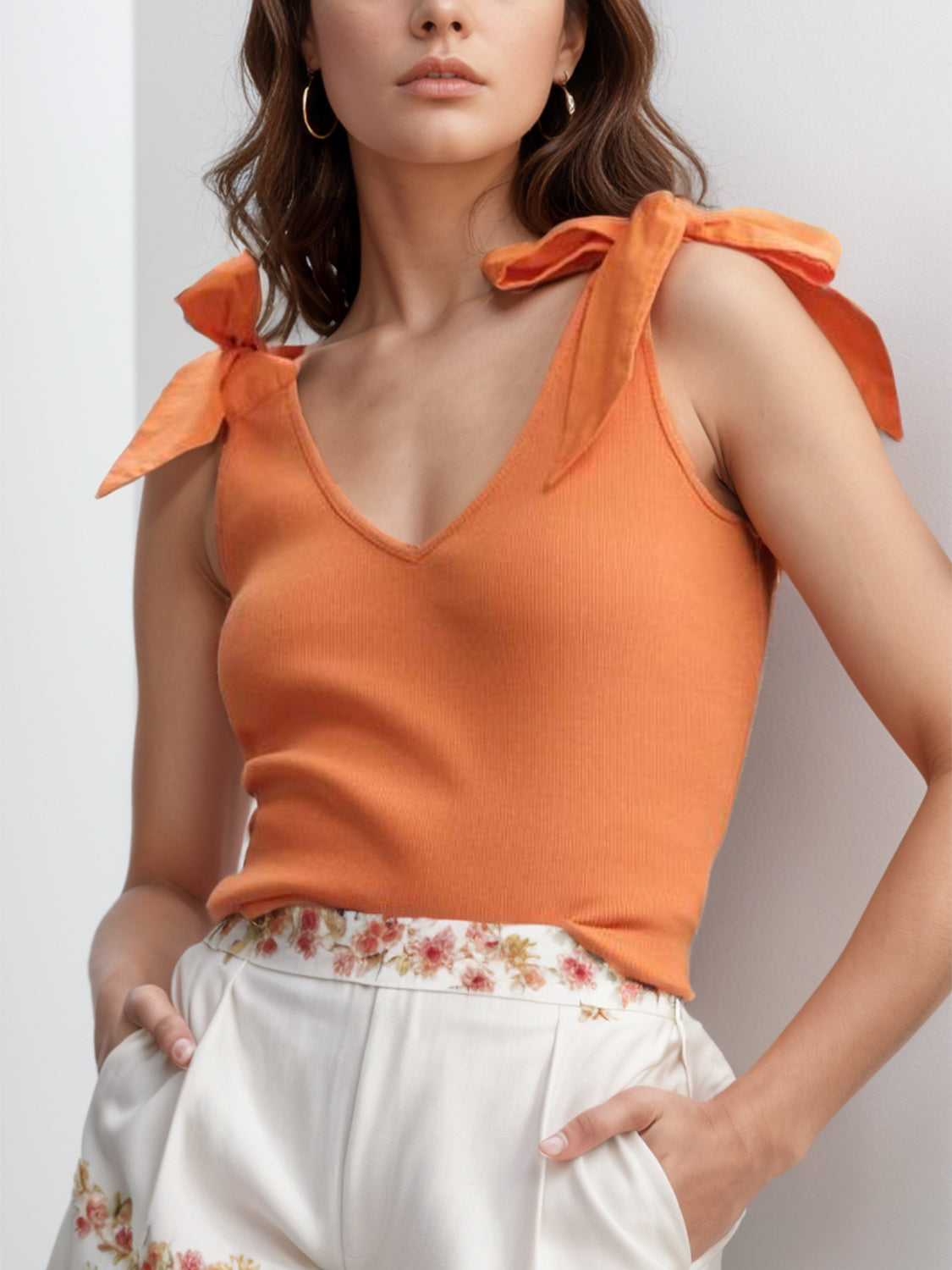 V-neck tie shoulder tank with bow, moderately stretchy.