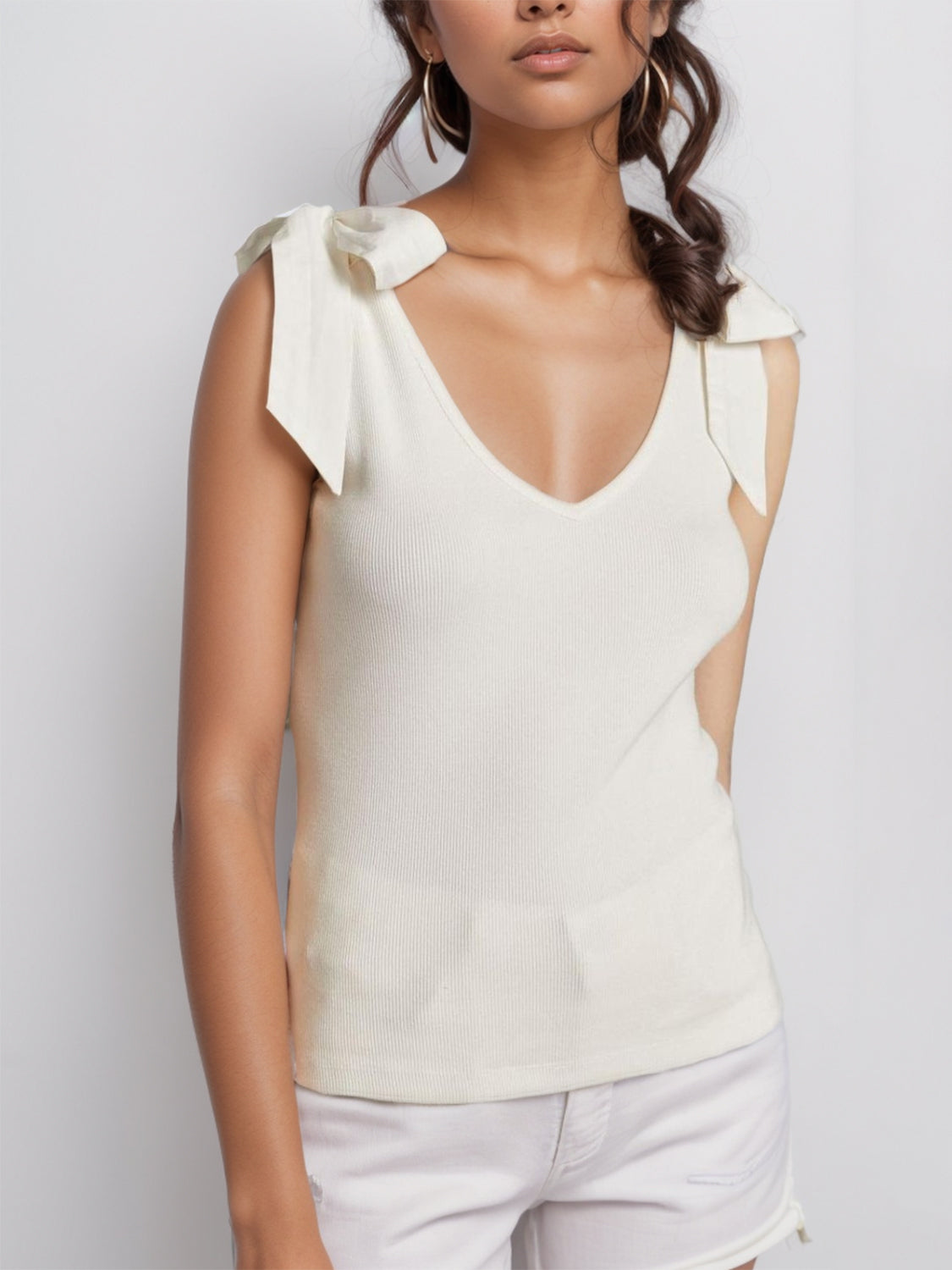 V-neck tie shoulder tank with bow, moderately stretchy.