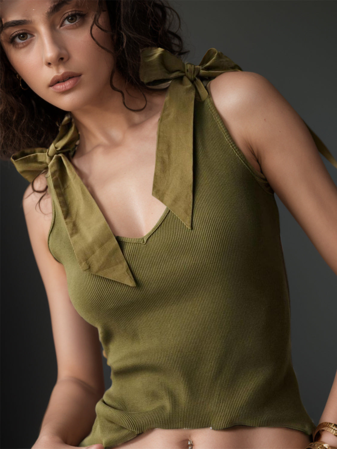 V-neck tie shoulder tank with bow, moderately stretchy.