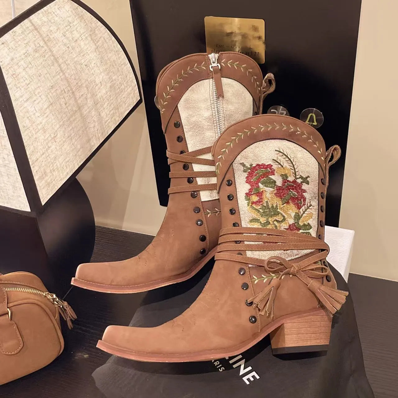Vintage floral embroidered western cowgirl boots with low heels.