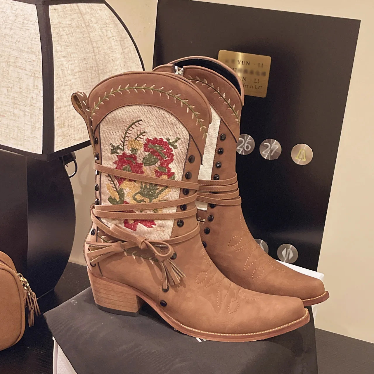 Vintage floral embroidered western cowgirl boots with low heels.