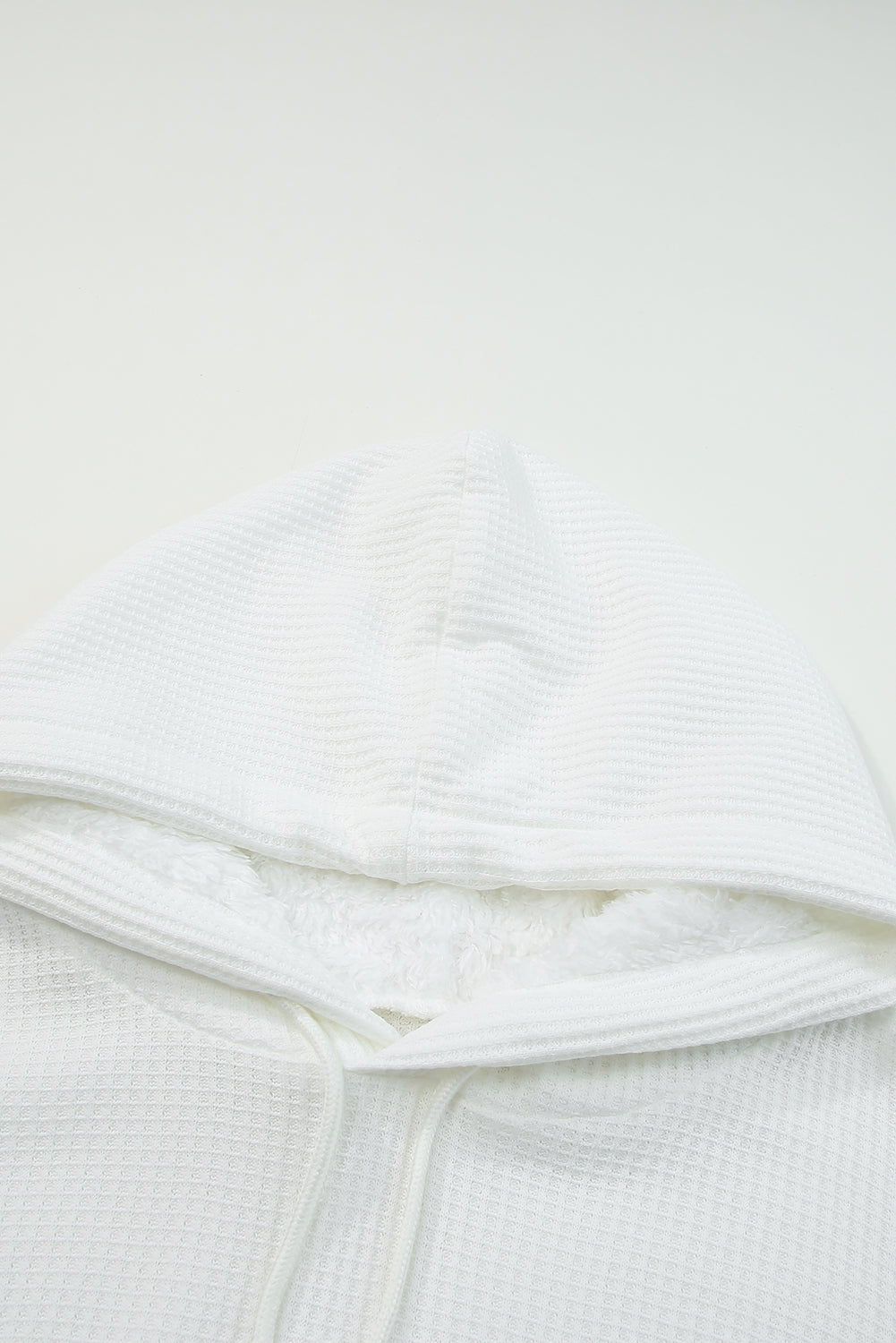 Waffle knit plaid long sleeve kangaroo pocket hoodie with drawstring.