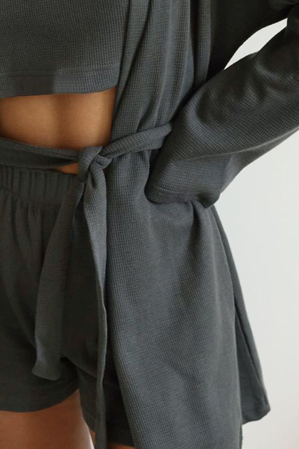 Three-piece set: waffle knit round neck T-shirt, open front cardigan, and shorts.