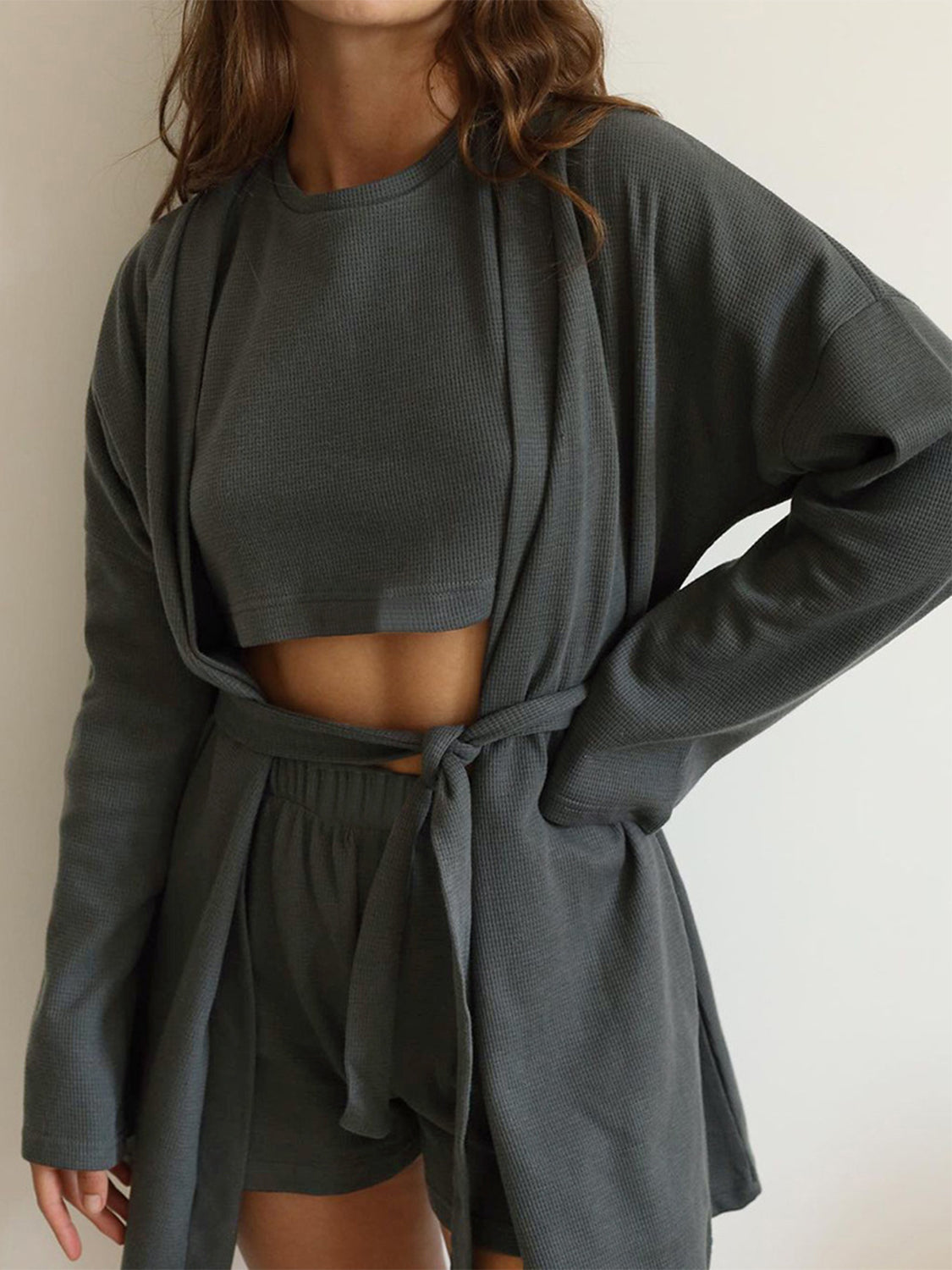 Three-piece set: waffle knit round neck T-shirt, open front cardigan, and shorts.