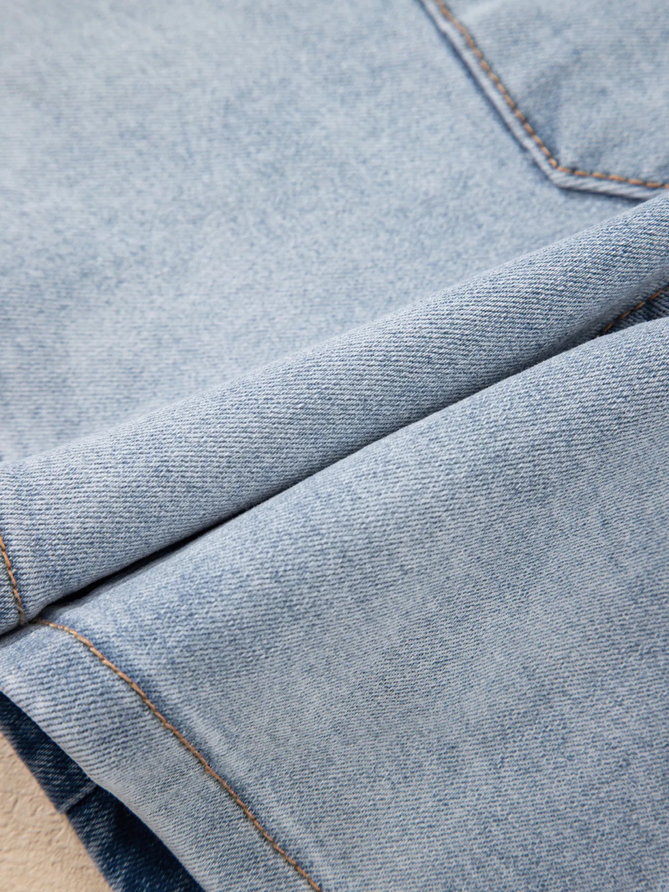 High-waist V-front Bermuda denim shorts with pockets.