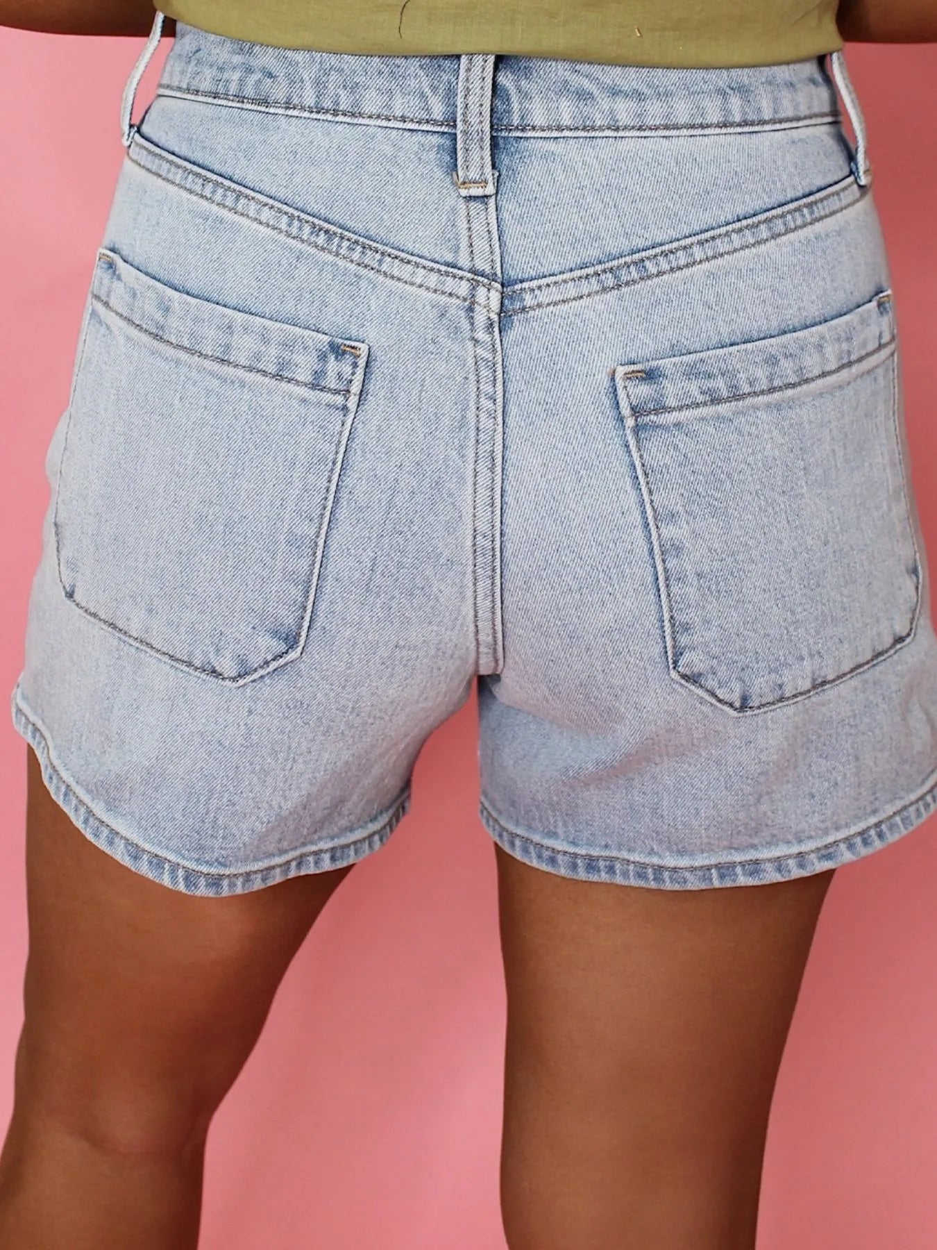 High-waist V-front Bermuda denim shorts with pockets.
