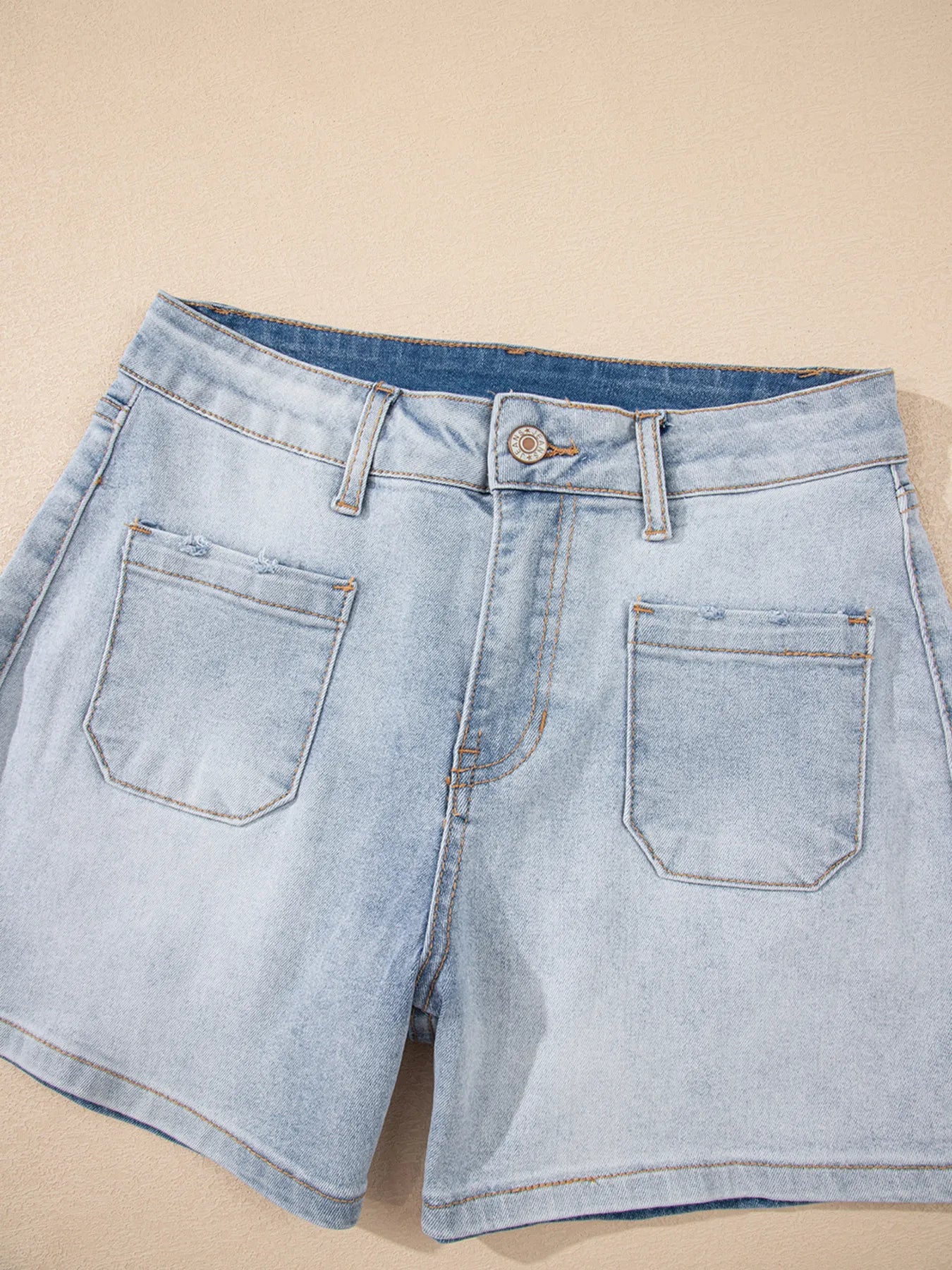 High-waist V-front Bermuda denim shorts with pockets.