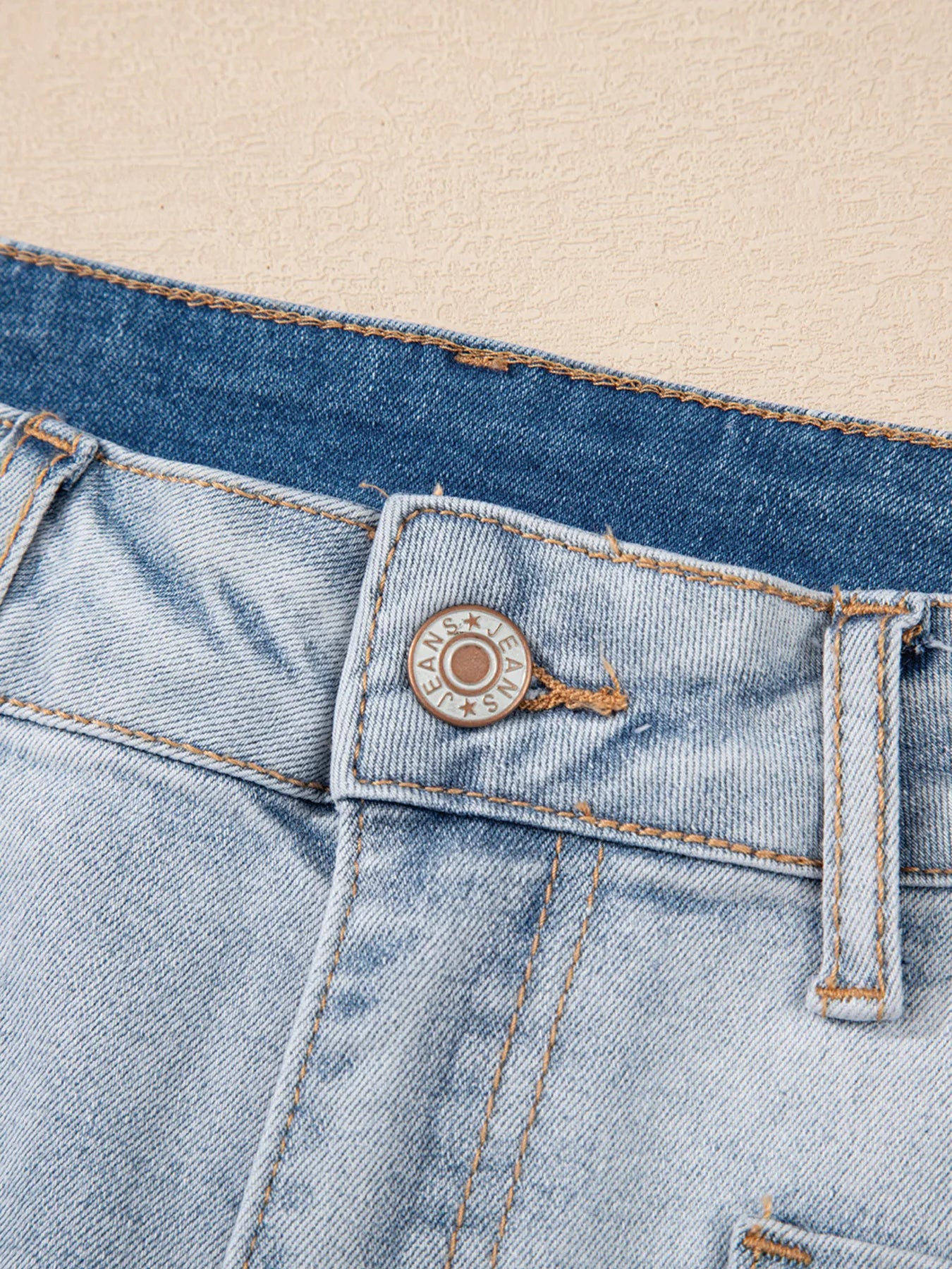 High-waist V-front Bermuda denim shorts with pockets.