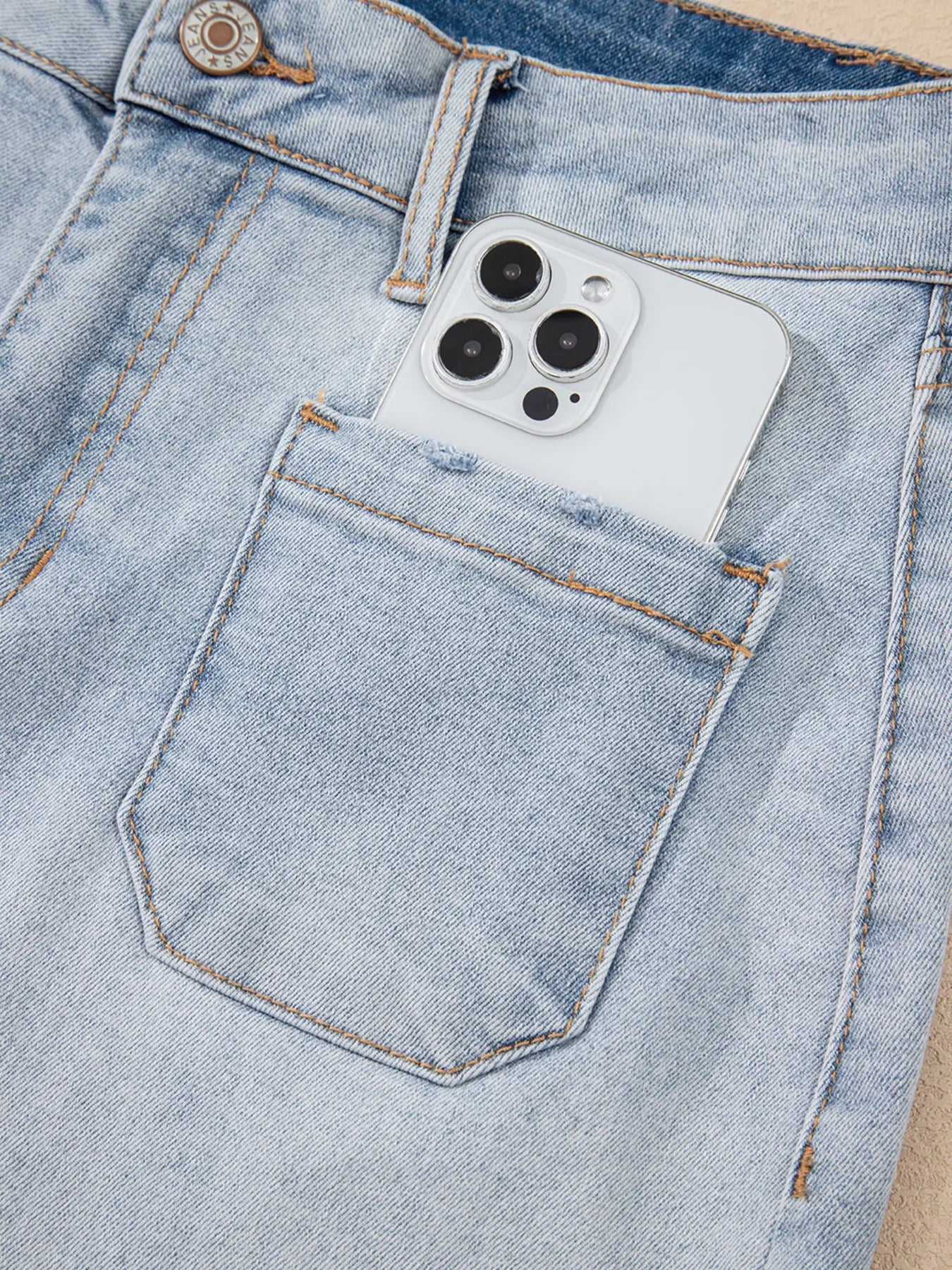 High-waist V-front Bermuda denim shorts with pockets.