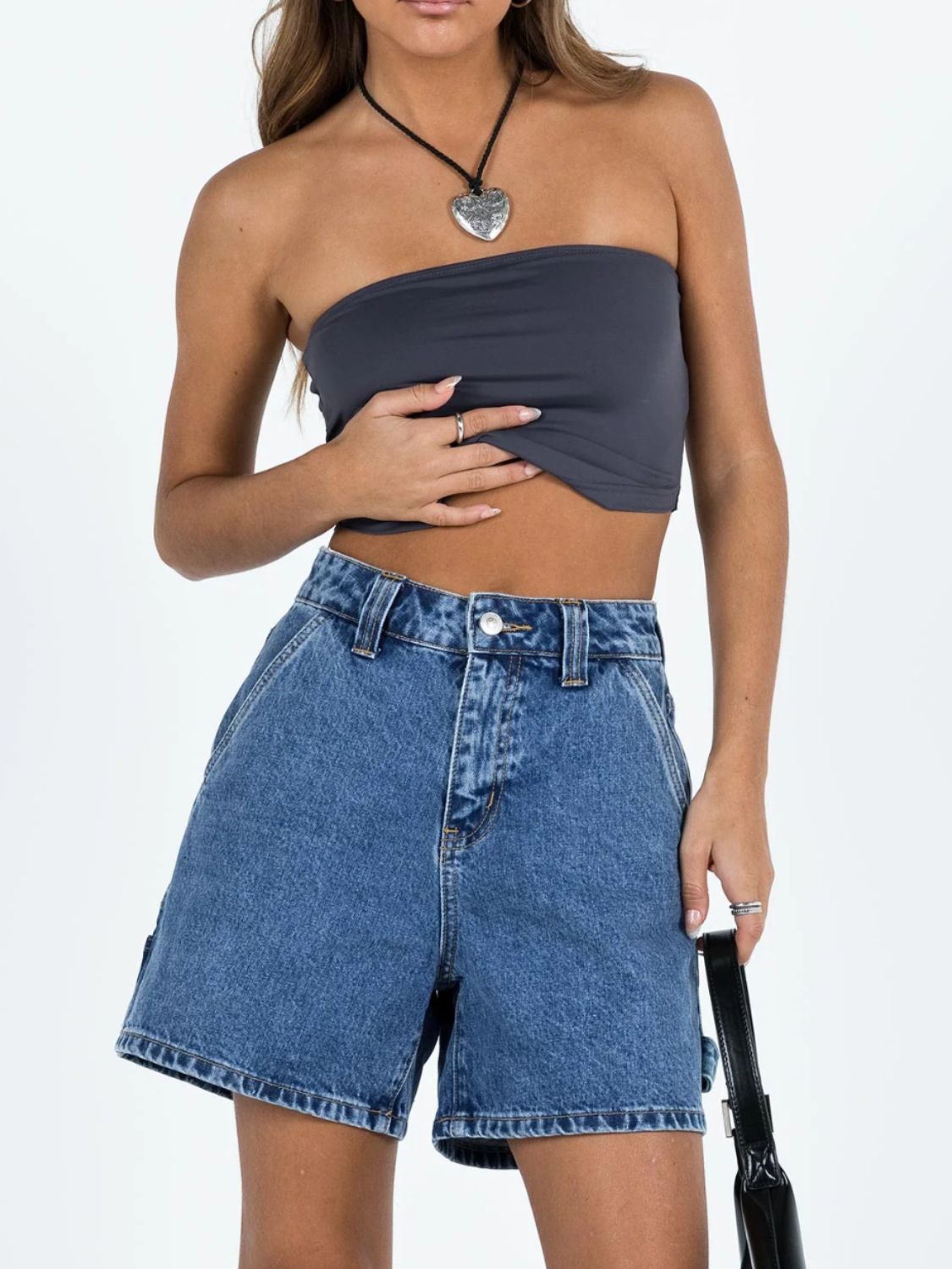 Distressed raw hem denim shorts with buttons and pockets.