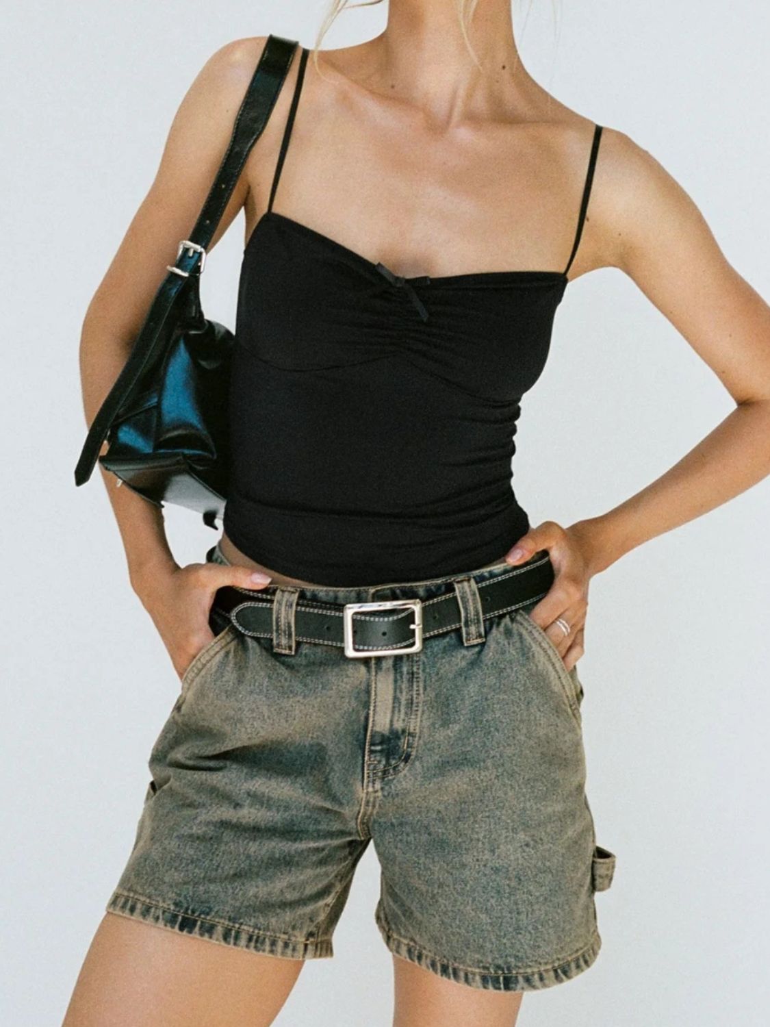 Distressed raw hem denim shorts with buttons and pockets.
