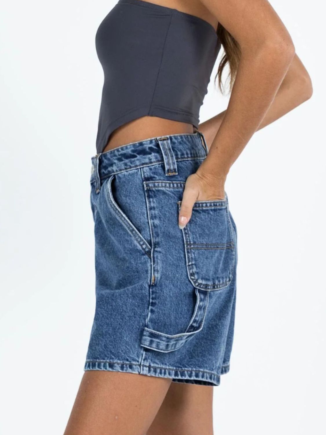 Distressed raw hem denim shorts with buttons and pockets.