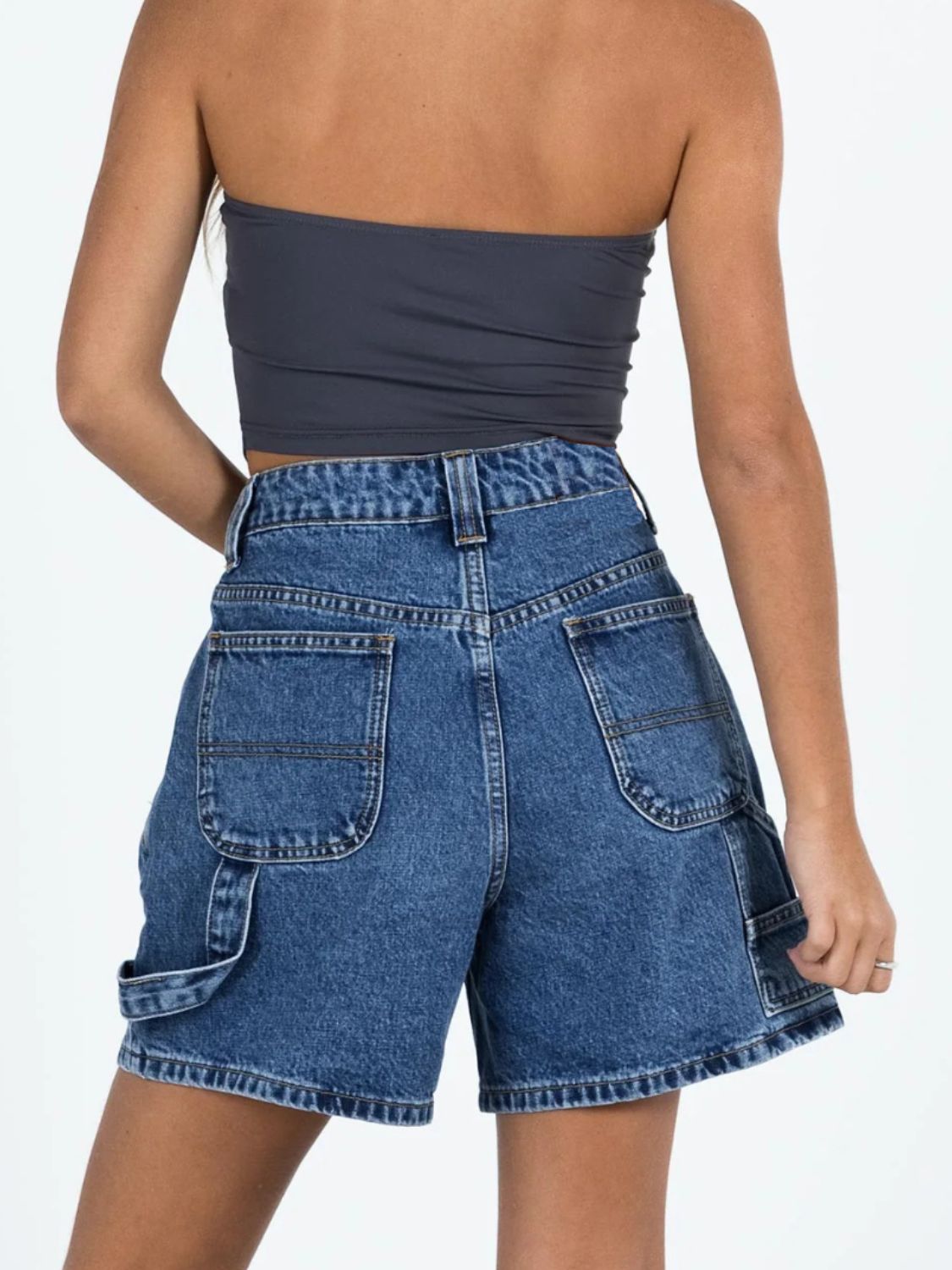 Distressed raw hem denim shorts with buttons and pockets.