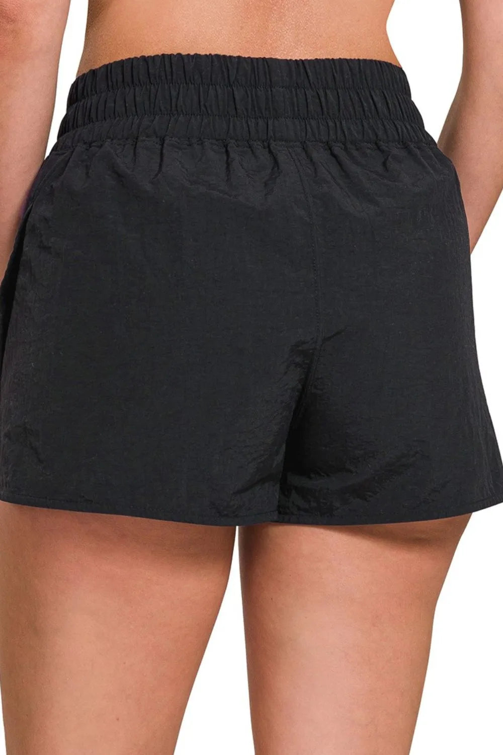 Gingham mini shorts with elastic waistband and decorative button.