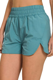 Windbreaker smocked waistband running shorts with slit, breathable, lightweight, and pockets.
