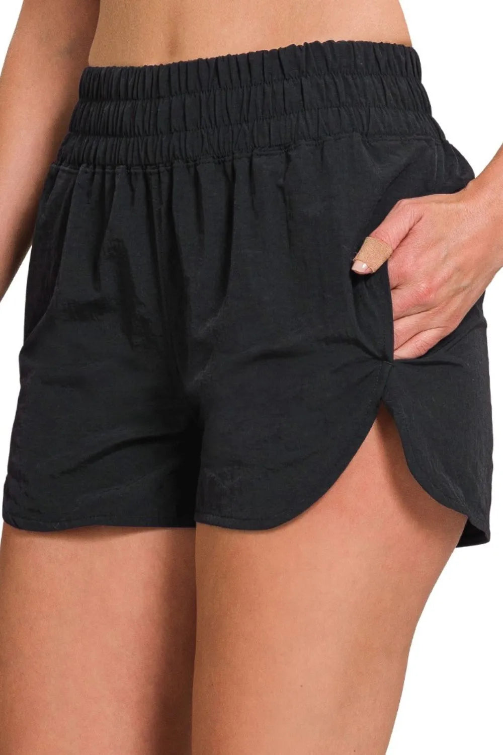 Gingham mini shorts with elastic waistband and decorative button.