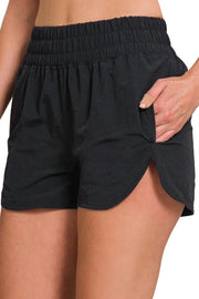 Gingham mini shorts with elastic waistband and decorative button.