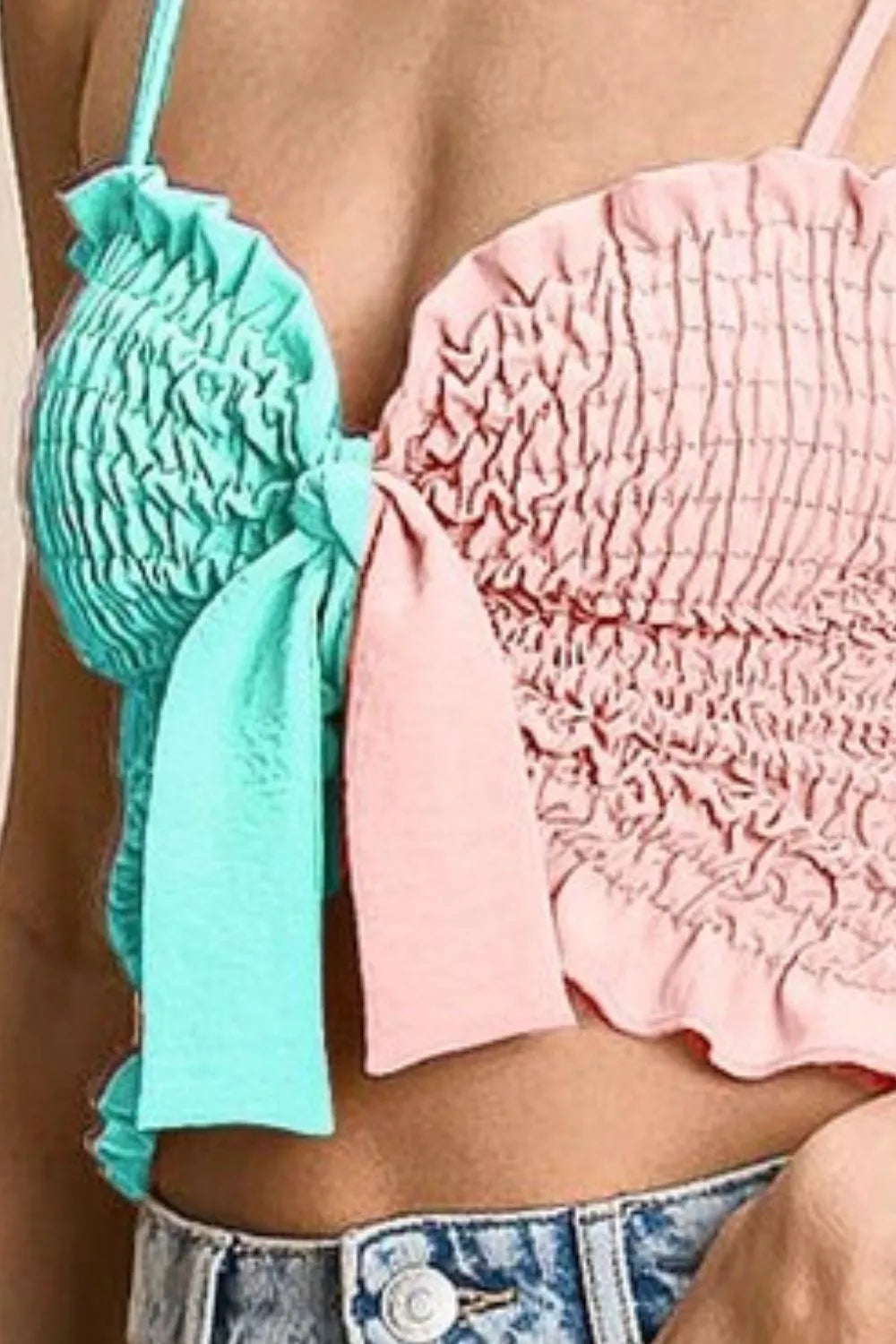 Woven color block smocked with ribbon bra top with tied ruffles, moderately stretchy.