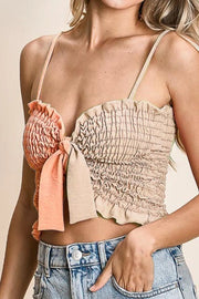 Woven color block smocked with ribbon bra top with tied ruffles, moderately stretchy.
