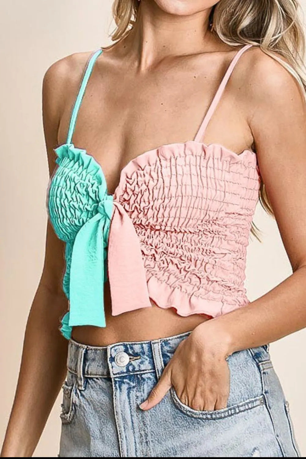 Woven color block smocked with ribbon bra top with tied ruffles, moderately stretchy.