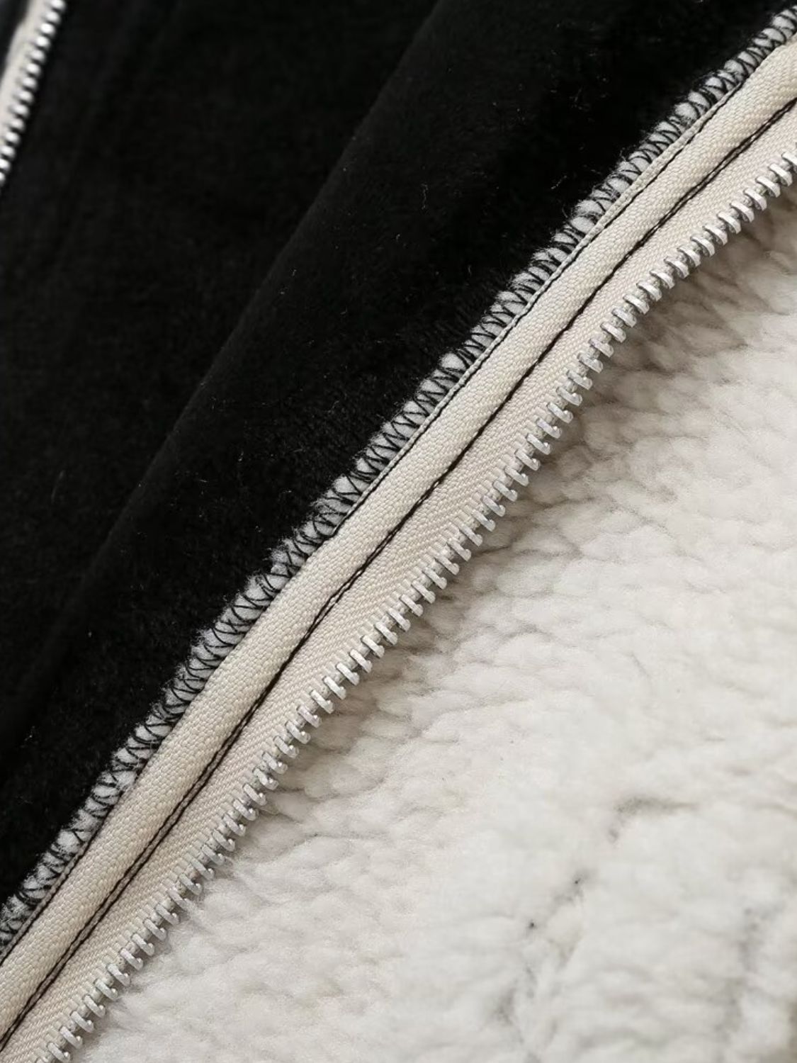Zip up long sleeve sherpa jacket with pockets and lined body.