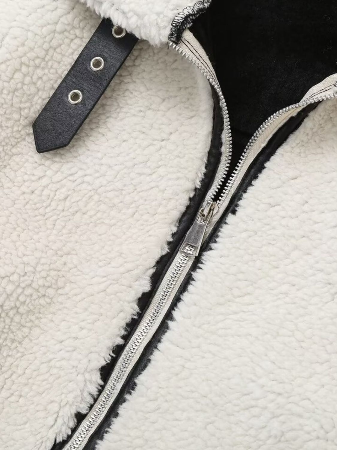 Zip up long sleeve sherpa jacket with pockets and lined body.