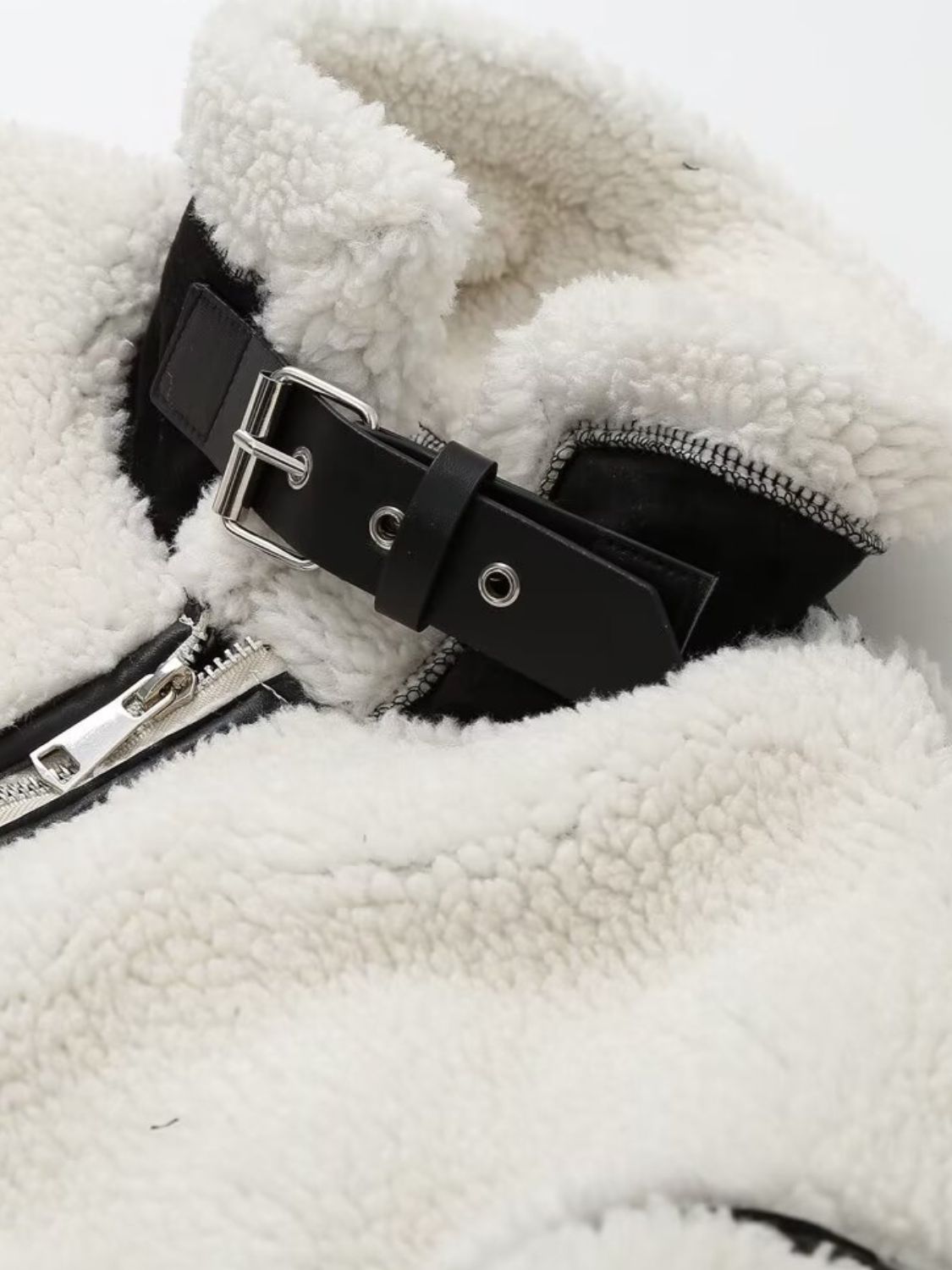 Zip up long sleeve sherpa jacket with pockets and lined body.