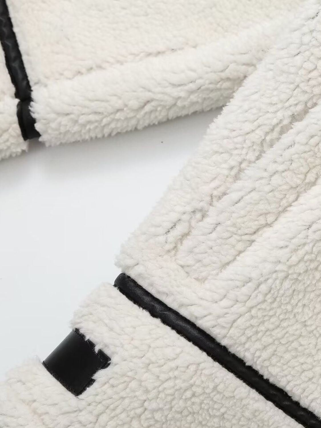 Zip up long sleeve sherpa jacket with pockets and lined body.