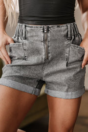 Distressed raw hem denim shorts with buttons and pockets.