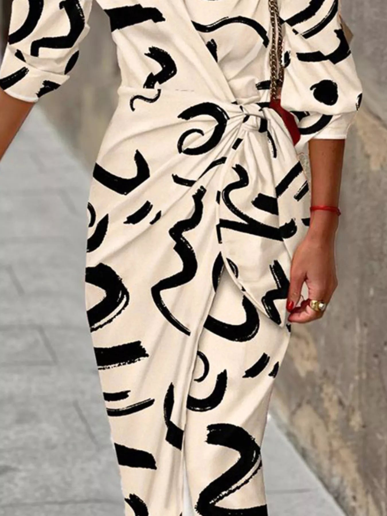 Green and red abstract-print collared midi shirt dress with three-quarter sleeves and a tied waist