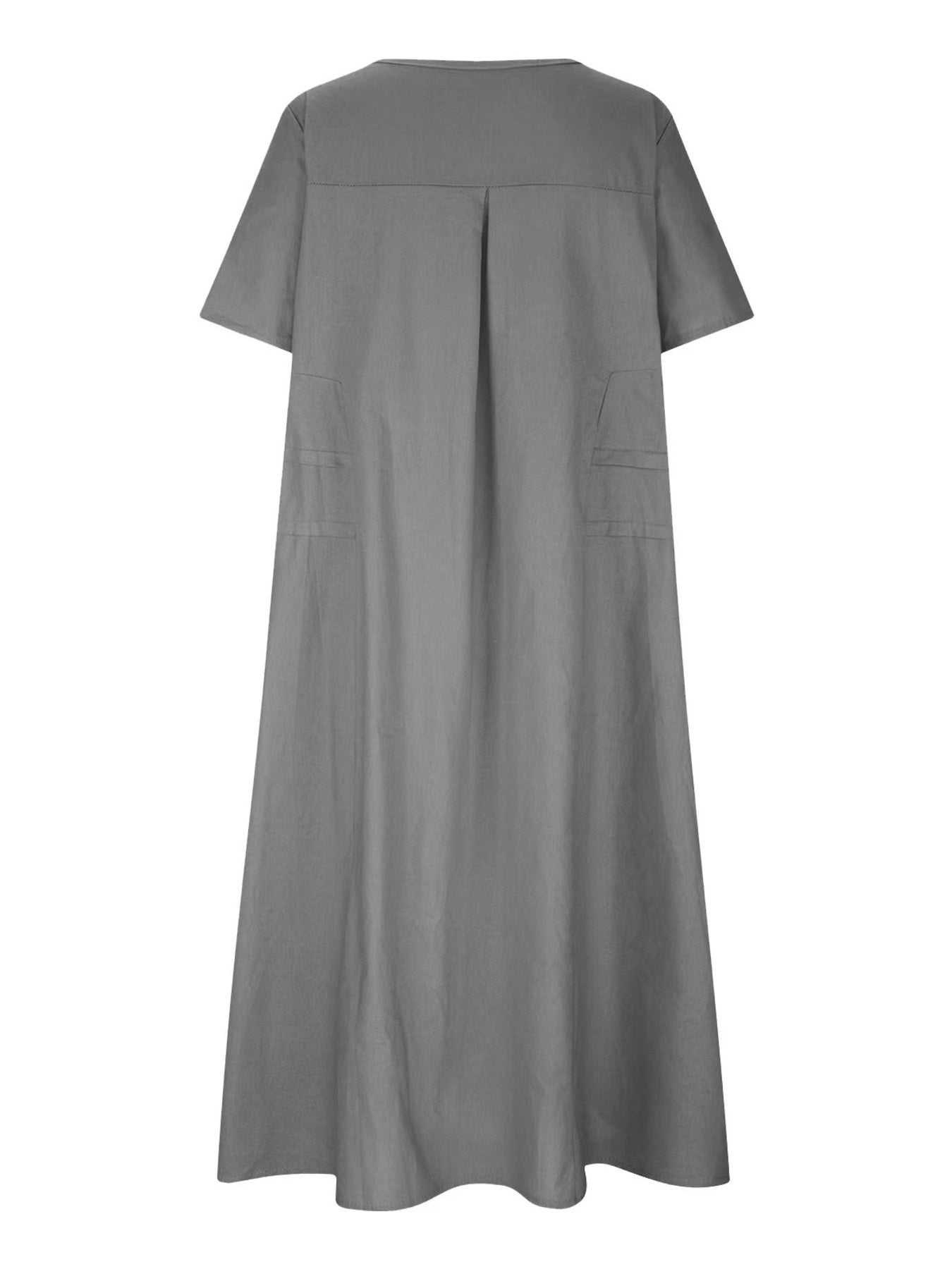 Plus size loose midi dress with short sleeves and pockets shown in cream and black by the beach