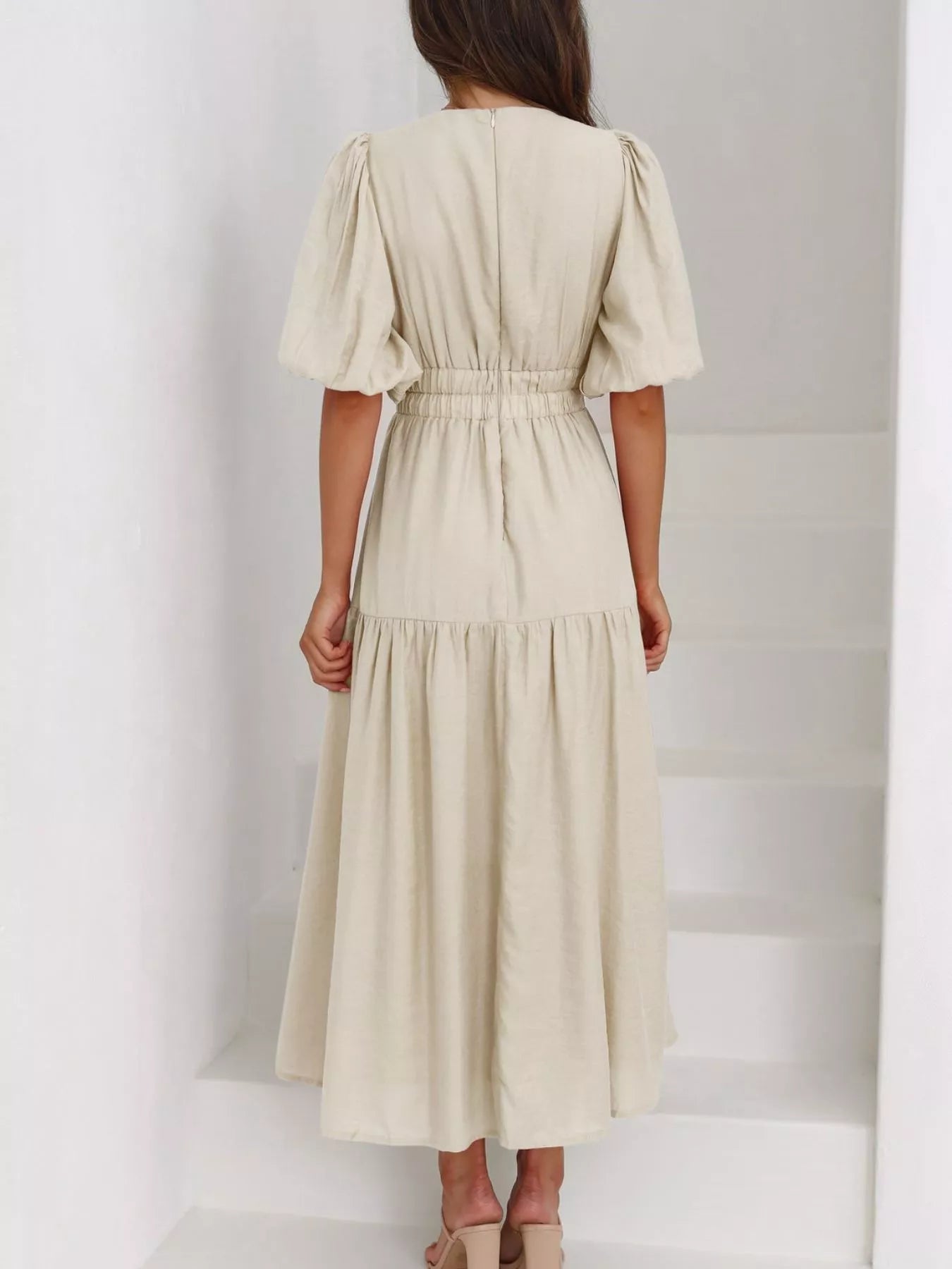 Cream tiered midi dress with a V-neck, smocked waist, and short puff sleeves