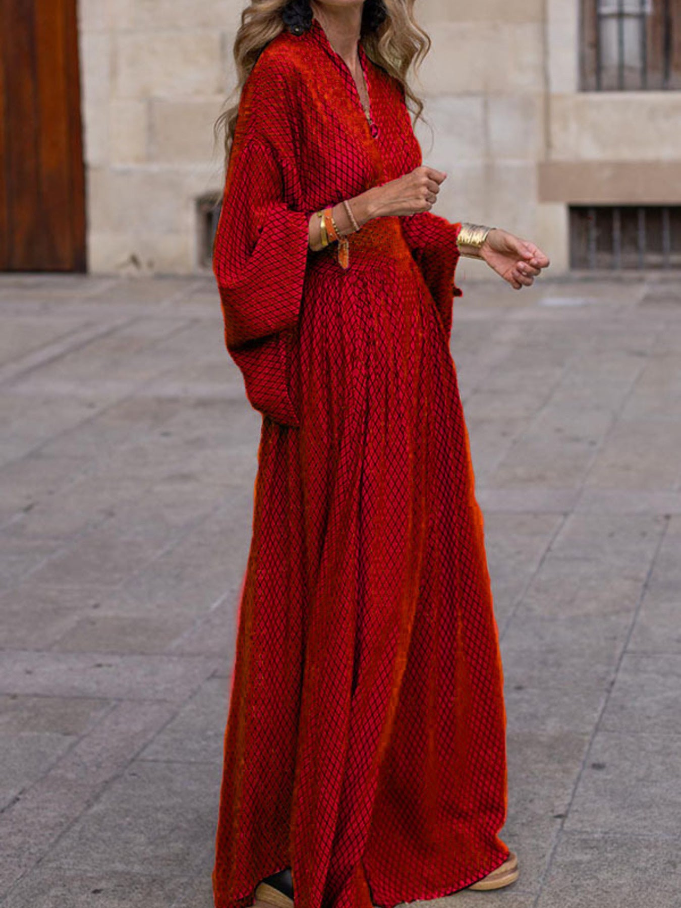 Flowy geometric maxi dress with V-neck and long sleeves in green, black, gray, red, and yellow