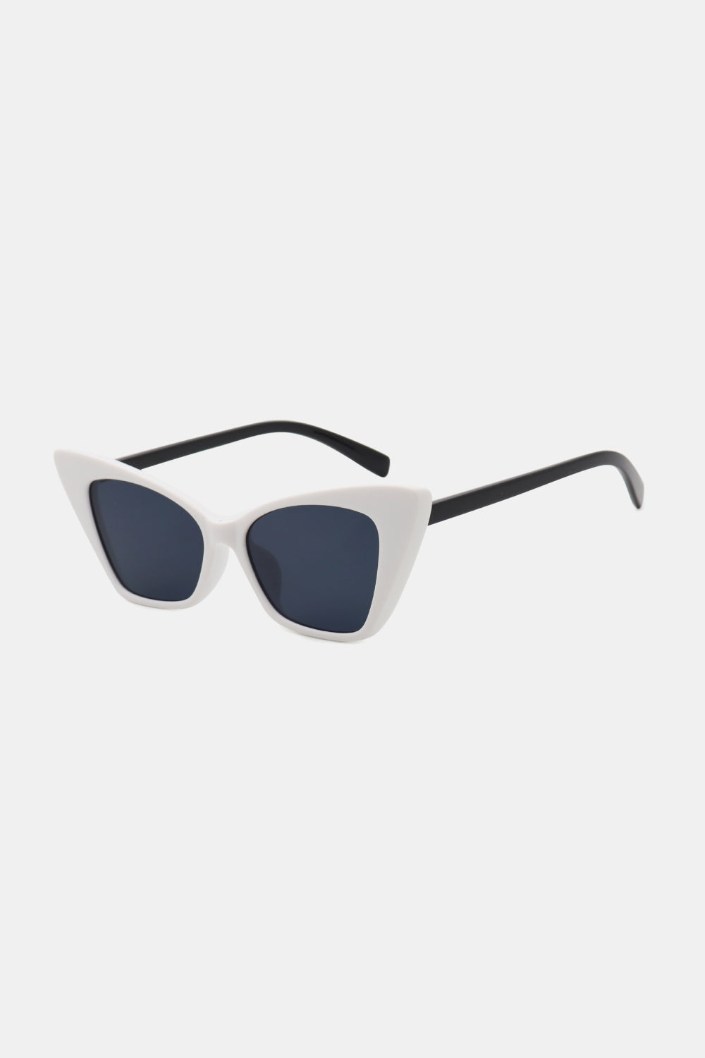 White sculpted cat-eye sunglasses feature upswept frames, dark acetate lenses, and contrasting black temples in a bold retro silhouette.