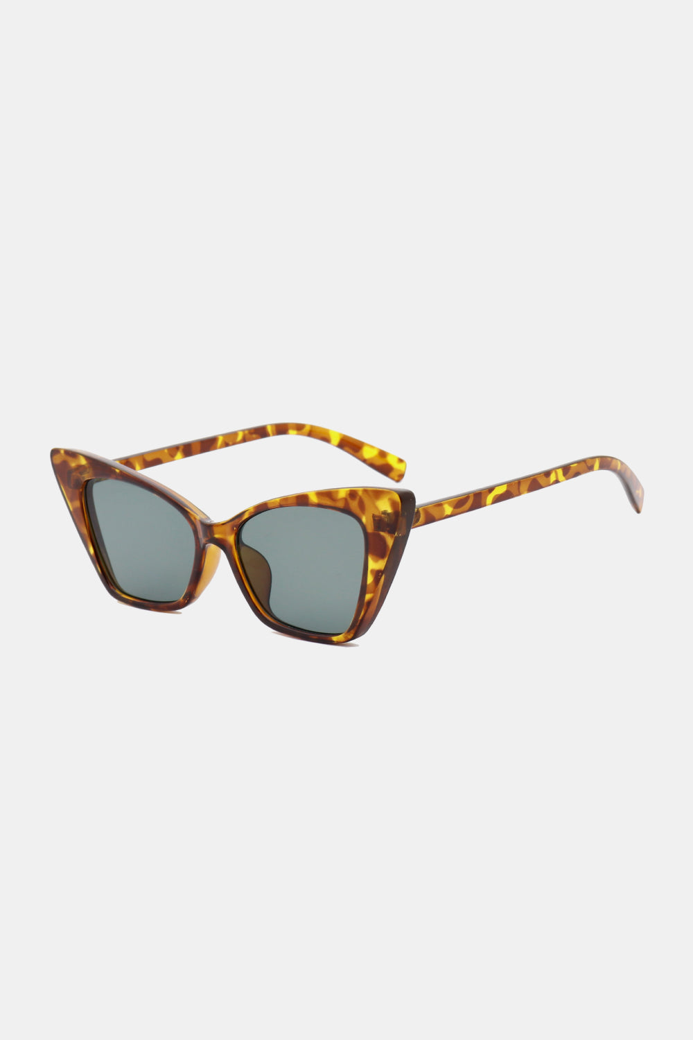 Tortoiseshell cat-eye sunglasses feature upswept sculpted polycarbonate frames, dark acetate lenses, and curved temples for a polished retro silhouette.