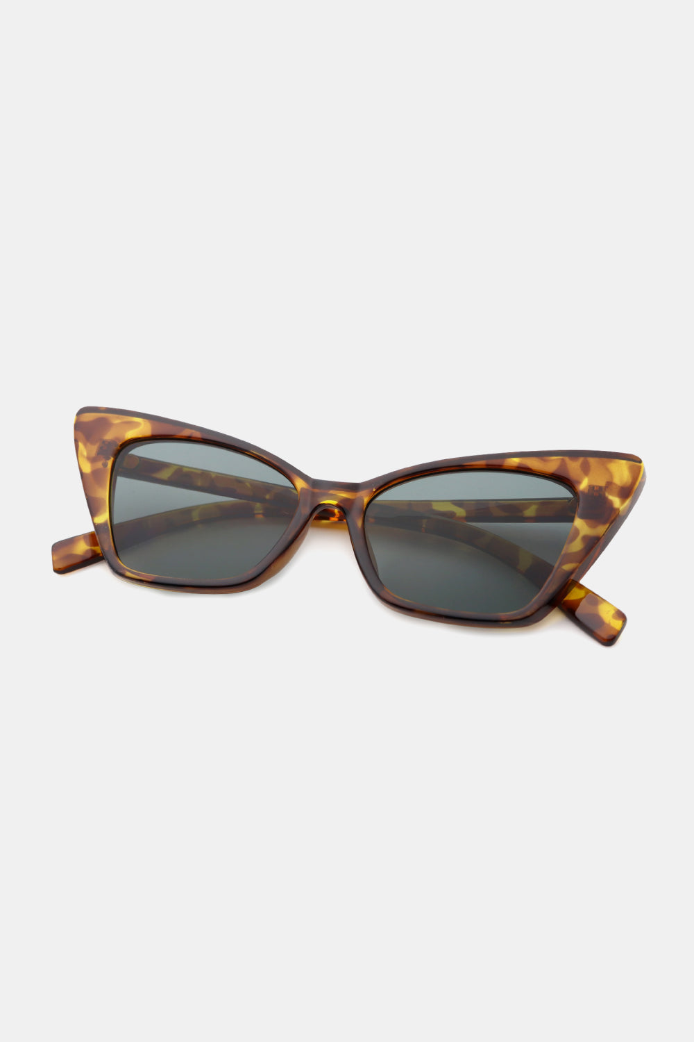 Brown tortoiseshell cat-eye sunglasses feature an upswept, sculpted polycarbonate frame, dark acetate lenses, and matching temples for a polished retro silhouette.