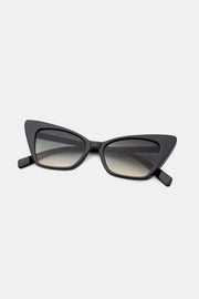 Black cat-eye sunglasses feature a sculpted, upswept polycarbonate frame, dark gradient acetate lenses, and sturdy temples for a polished retro silhouette.