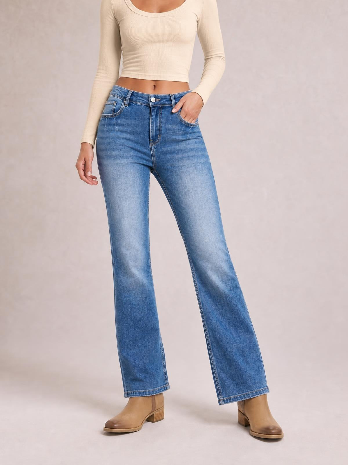 Model wears blue acid-washed straight-leg jeans with full-length hems, front and back pockets, belt loops, button fly, and a relaxed silhouette.
