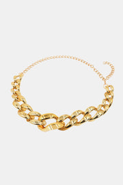 Gold acrylic chain belt featuring bold interlocking links at the front and a slimmer chain extension for adjustable styling at the waist or hips.