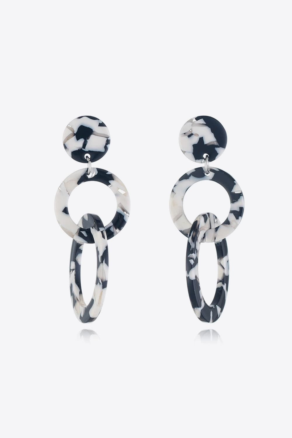 Acrylic Double-Hoop Earrings feature bold black-and-white marbled round studs with linked circular and elongated oval hoops for a sculptural statement silhouette.