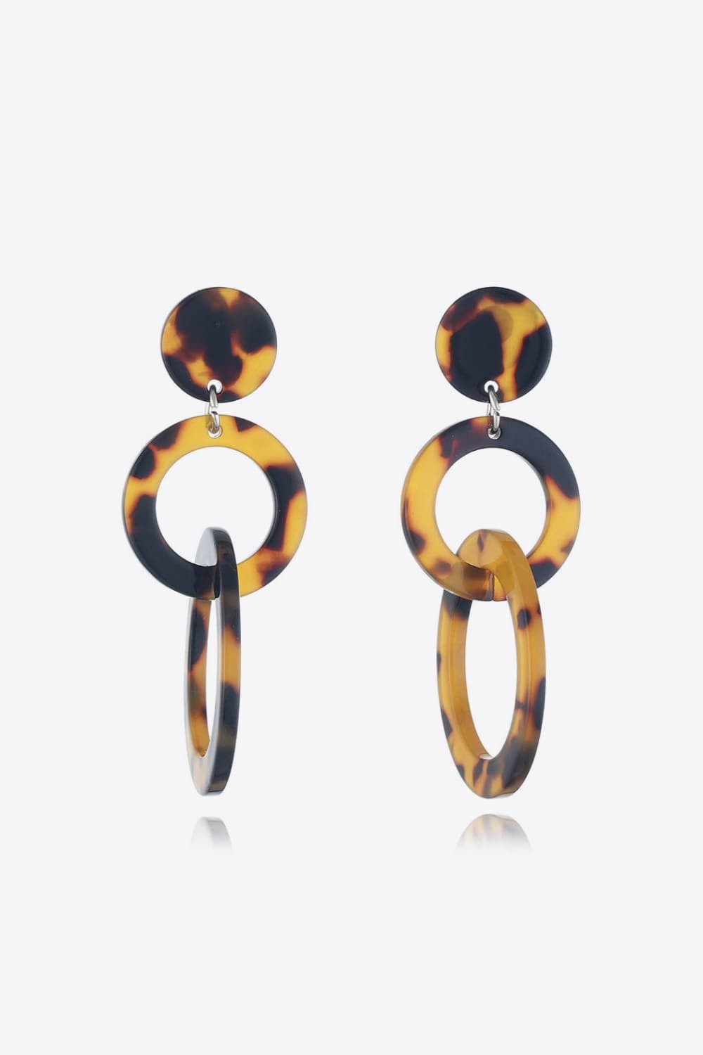 Tortoiseshell acrylic double-hoop earrings feature round studs, linked circular hoops, and elongated oval drops for a bold layered silhouette.