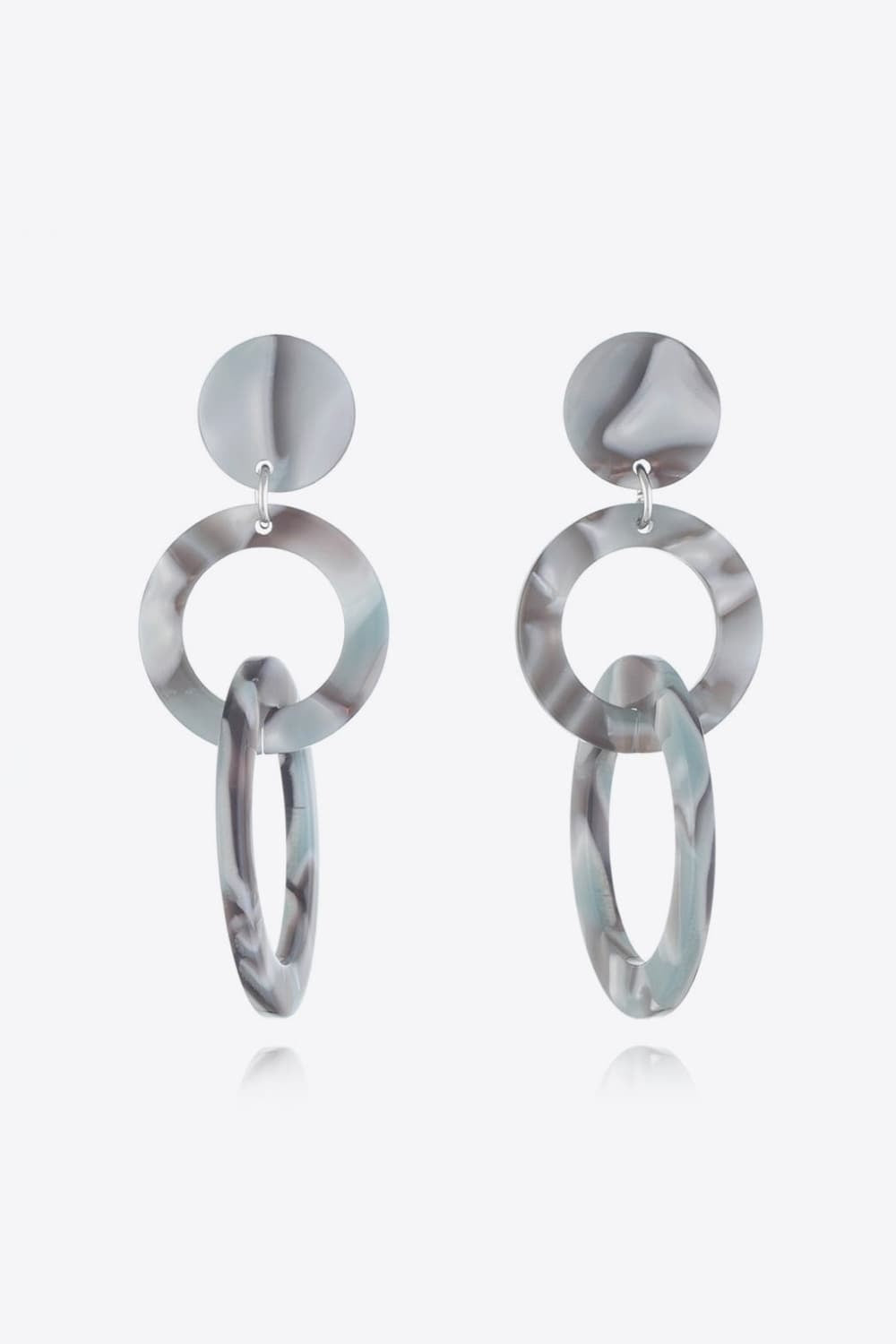 Acrylic Double-Hoop Earrings feature a sculptural marbled gray design with round studs, large circular hoops, and elongated dangling hoops.