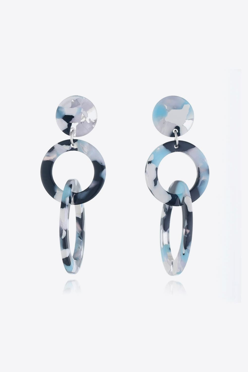 Acrylic Double-Hoop Earrings feature polished marbled blue, black, and white round hoops layered with elongated oval hoops for a sculptural statement silhouette.