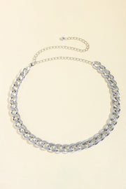 Silver-tone adjustable curb chain belt featuring bold interlocking links and a slender extension chain for versatile wear at the waist or hips.